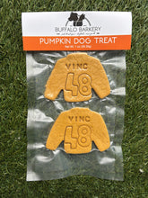 Load image into Gallery viewer, Pumpkin dog treats with 'Vinc 48' design in a clear packaging on grass.