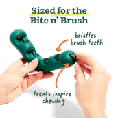 Load image into Gallery viewer, Teal dog toy with a treat being inserted held by hands against a white background