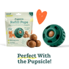 Pet product packaging with paw-shaped refill and a green pet toy on a black background
